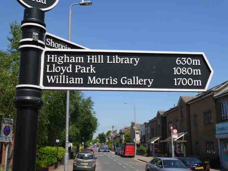 A Higham Hill street signpost pointing to Higham Hill Library, Lloyd Park and the William Morris Gallery